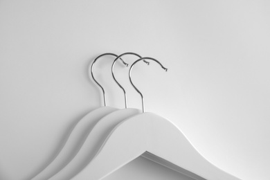 Photo of Empty clothes hangers on white background, top view