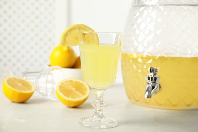 Photo of Delicious refreshing lemonade and fruits on light table