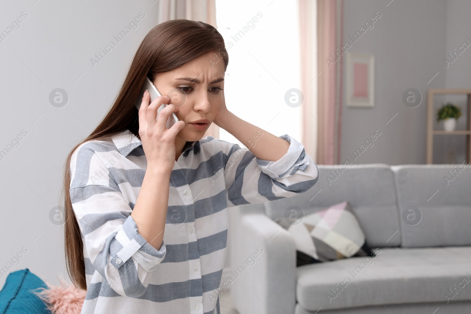 Photo of Woman arguing on mobile phone at home