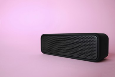 Photo of One portable bluetooth speaker on pink background, space for text. Audio equipment