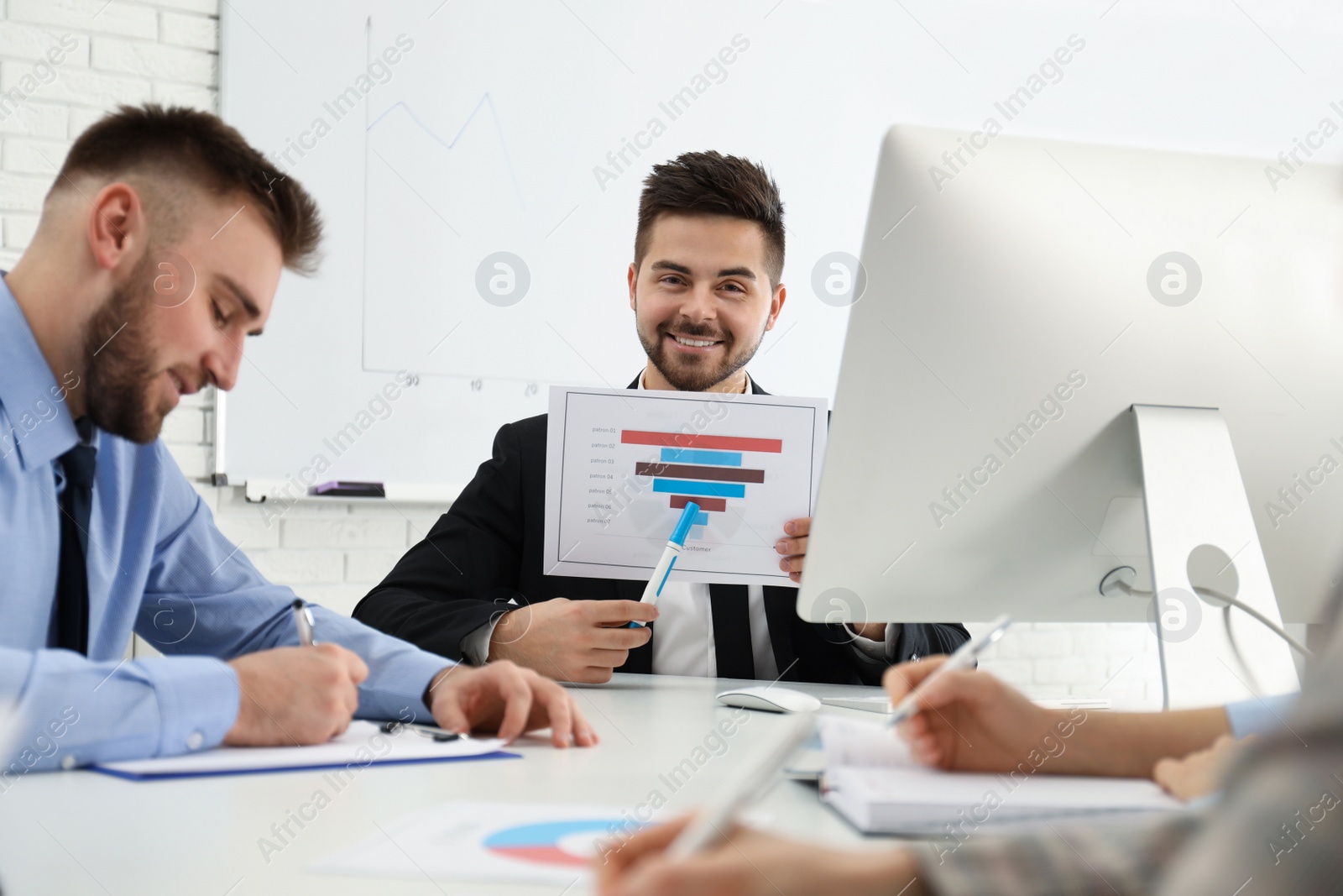 Photo of Professional business trainer working with people in office