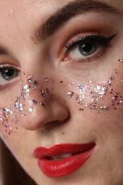 Photo of Beautiful woman with glitter freckles, closeup view