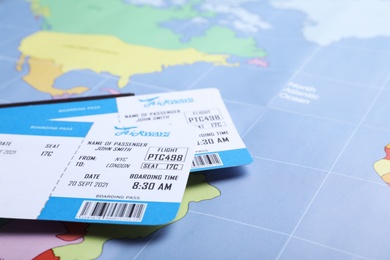 Photo of Tickets on world map, closeup. Travel agency concept