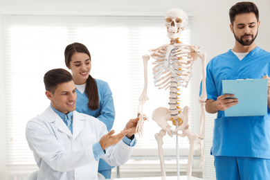 Professional orthopedist teaching medical students in clinic