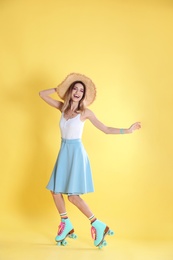 Photo of Young woman with retro roller skates on color background