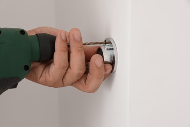 Worker installing new metal pipes with electric drill, closeup