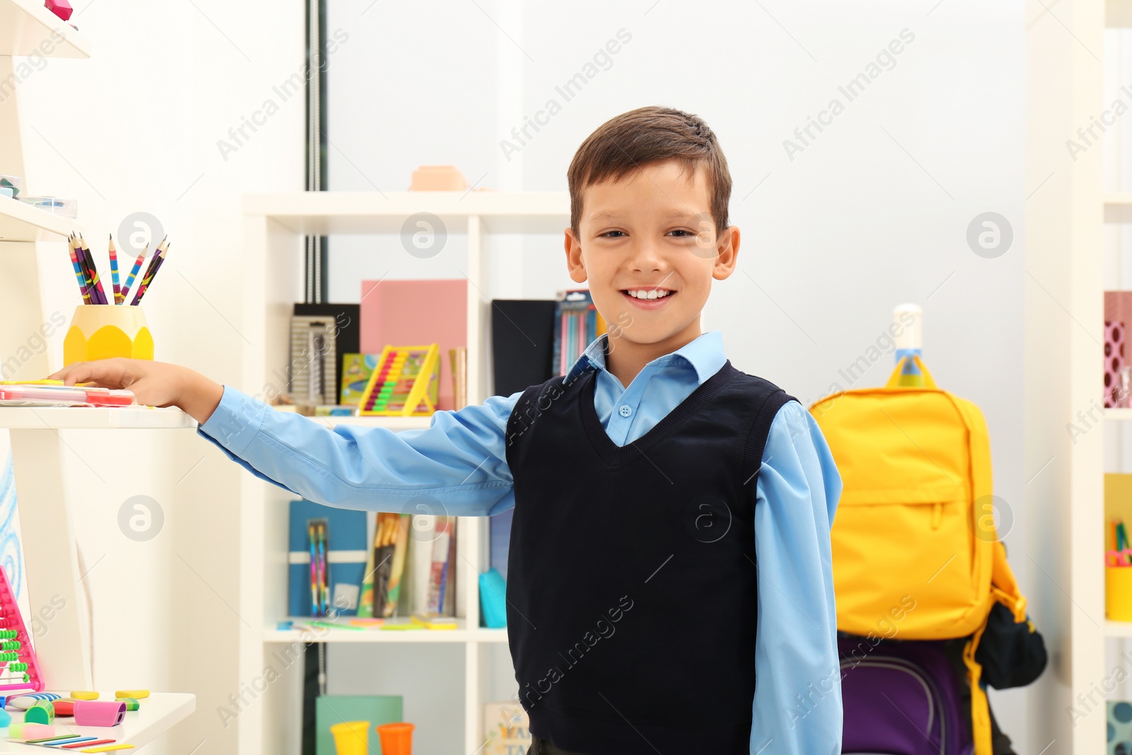 Photo of Cute child choosing school stationery in store