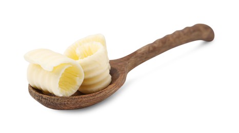 Tasty butter curls in spoon isolated on white