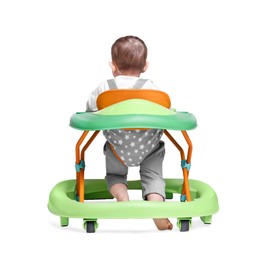 Cute little boy making first steps with baby walker on white background, back view