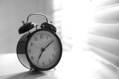 Photo of Alarm clock on windowsill, space for text. Morning time