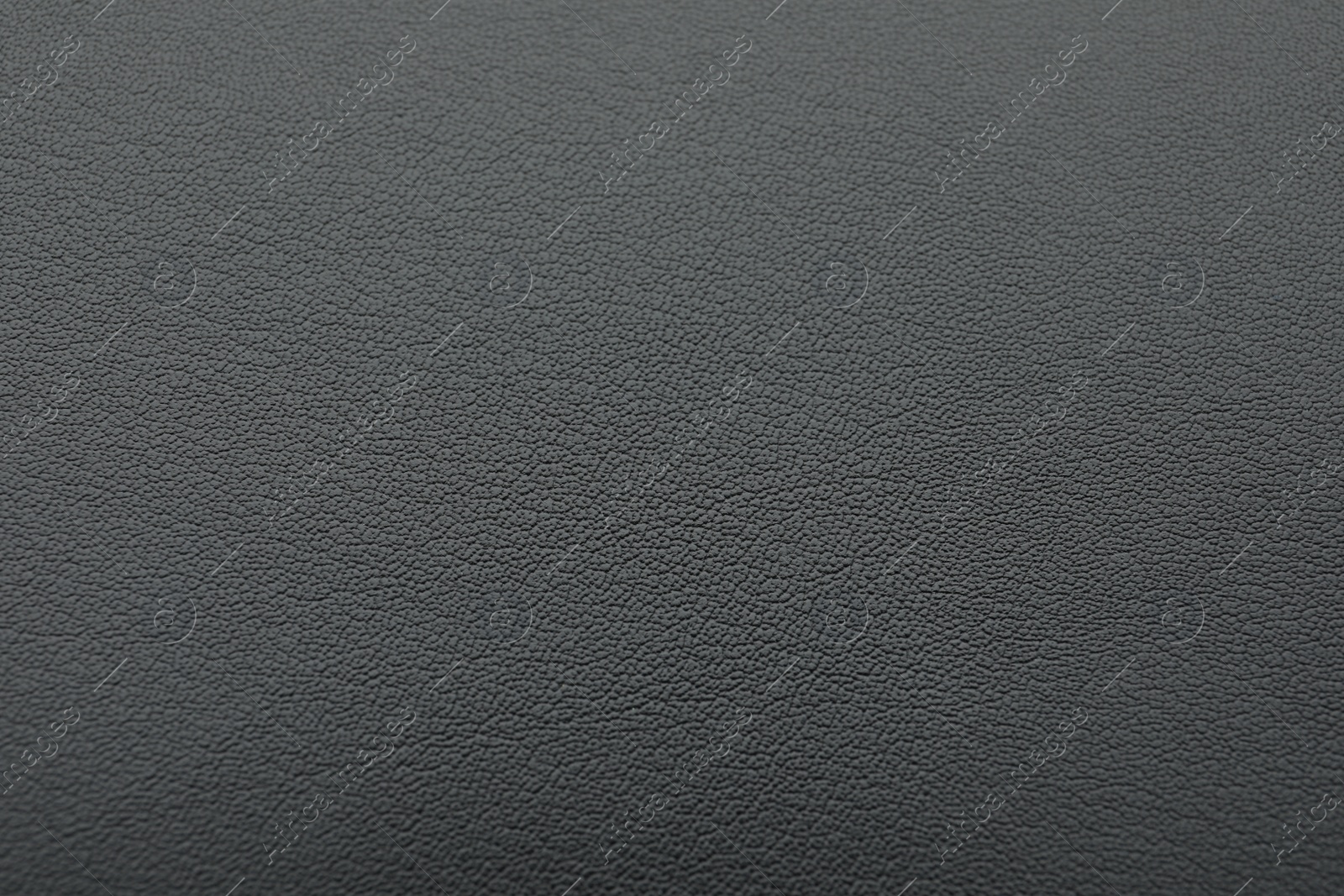 Photo of Texture of dark grey leather as background, closeup