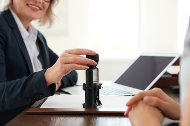 Female notary working with client in office