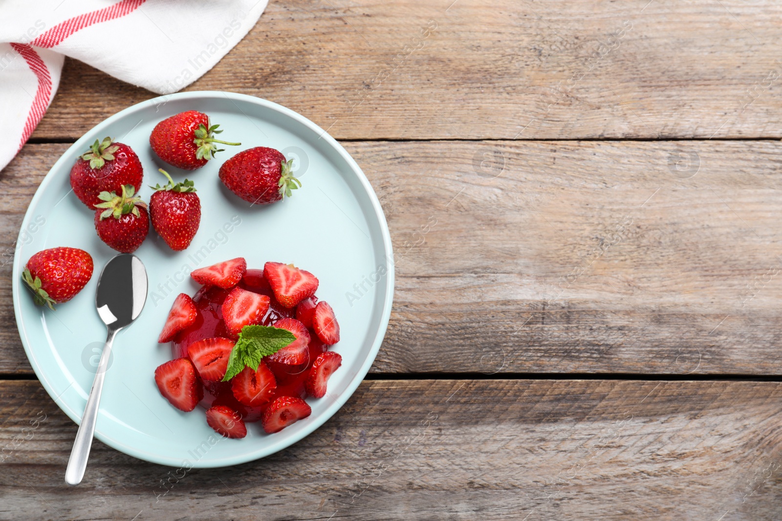 Photo of Delicious fresh red jelly with strawberries and mint on wooden table, flat lay. Space for text