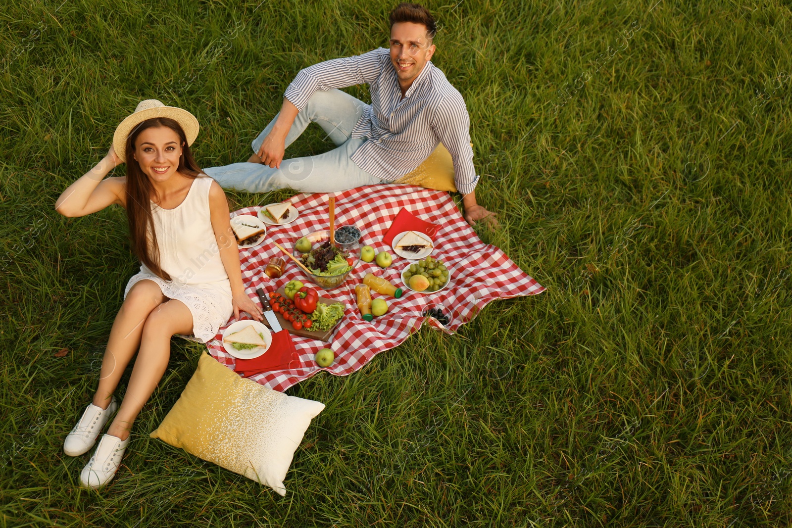 Photo of Happy couple having picnic in park on sunny day, above view