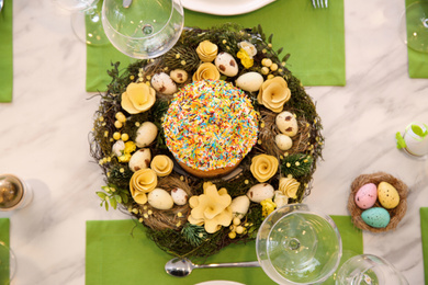 Photo of Festive table setting with traditional Easter bread, flat lay