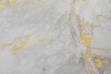 Image of Beautiful light gray and gold marble surface as background