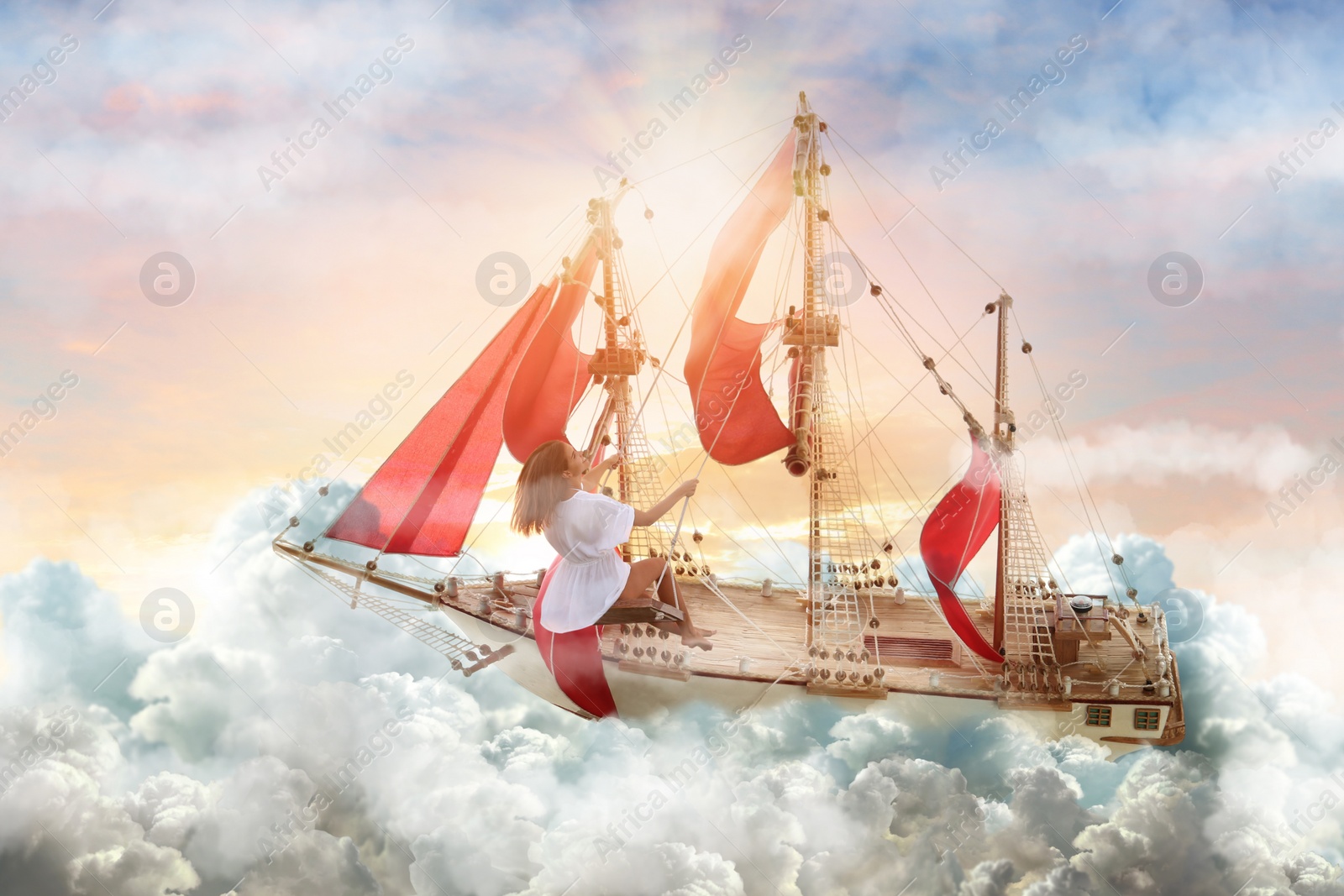 Image of Dream world. Sailing ship with beautiful girl on board floating among wonderful fluffy clouds