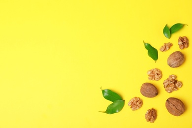 Photo of Flat lay composition with walnuts and space for text on color background