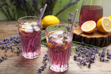 Fresh delicious lemonade with lavender and straws on wooden table