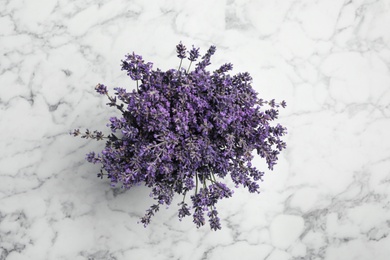 Beautiful lavender bouquet on white marble table, top view