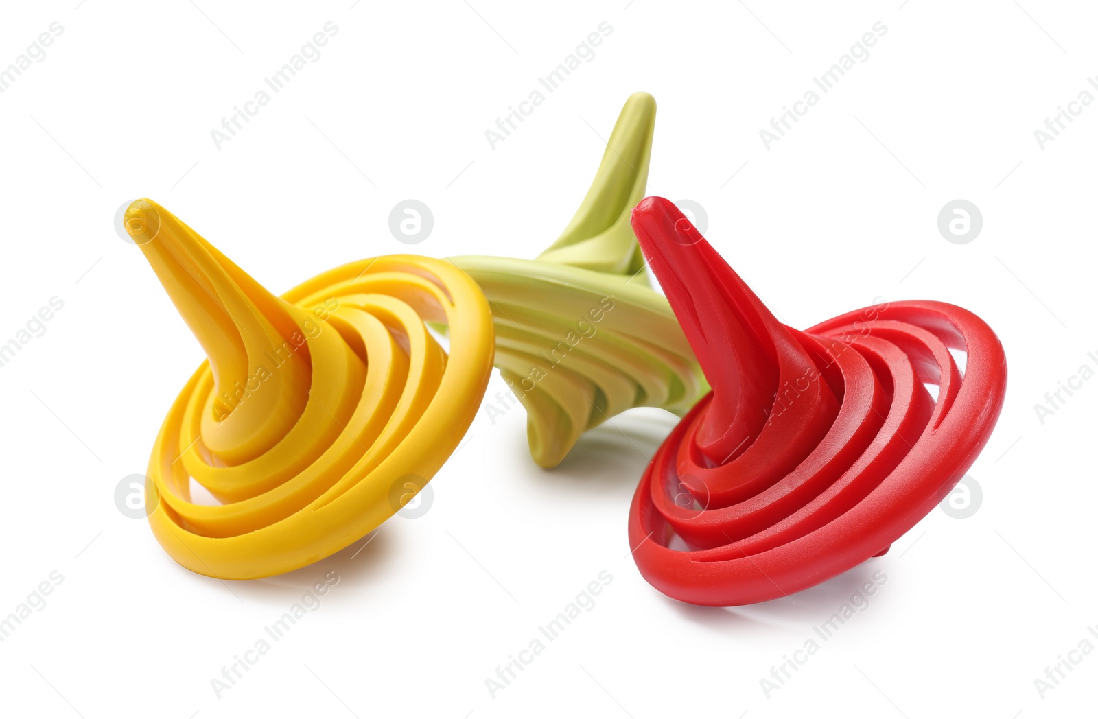 Photo of Three colorful spinning tops on white background