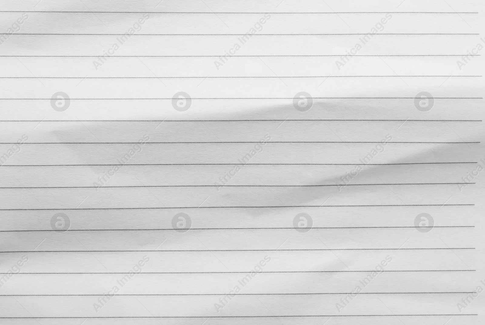 Photo of Crumpled lined notebook sheet as background, top view