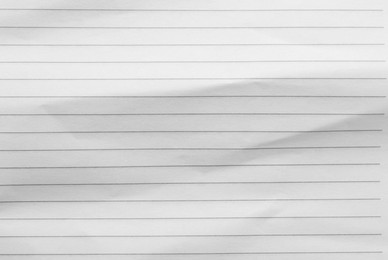 Photo of Crumpled lined notebook sheet as background, top view