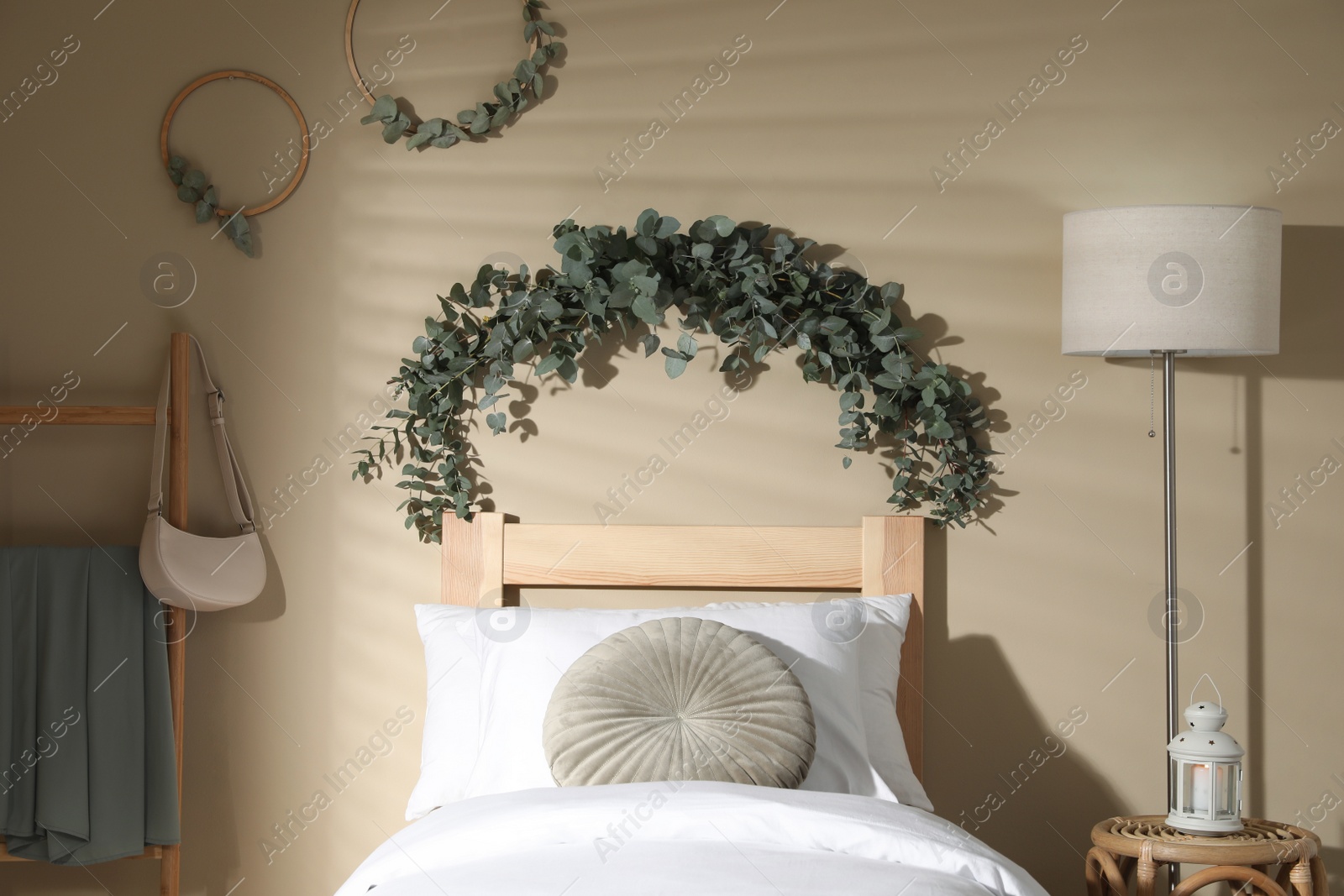 Photo of Stylish bedroom decorated with beautiful eucalyptus garland