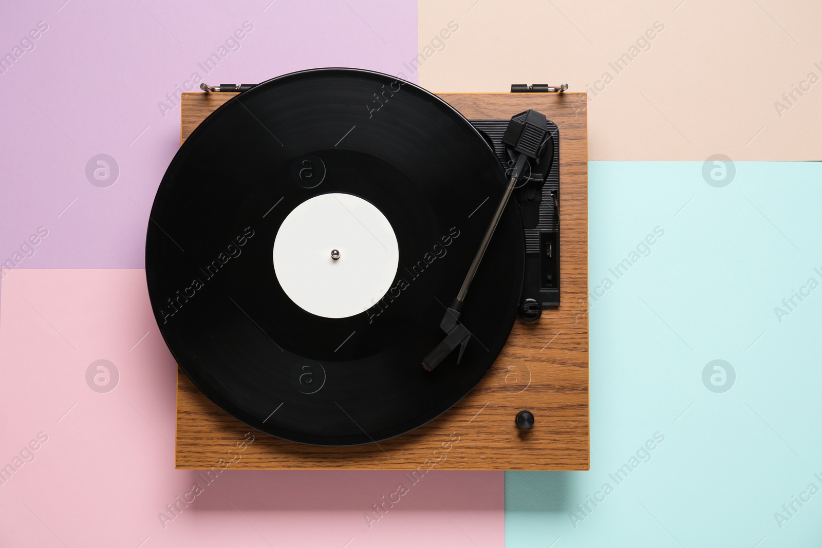 Photo of Turntable with vinyl record on color background, top view