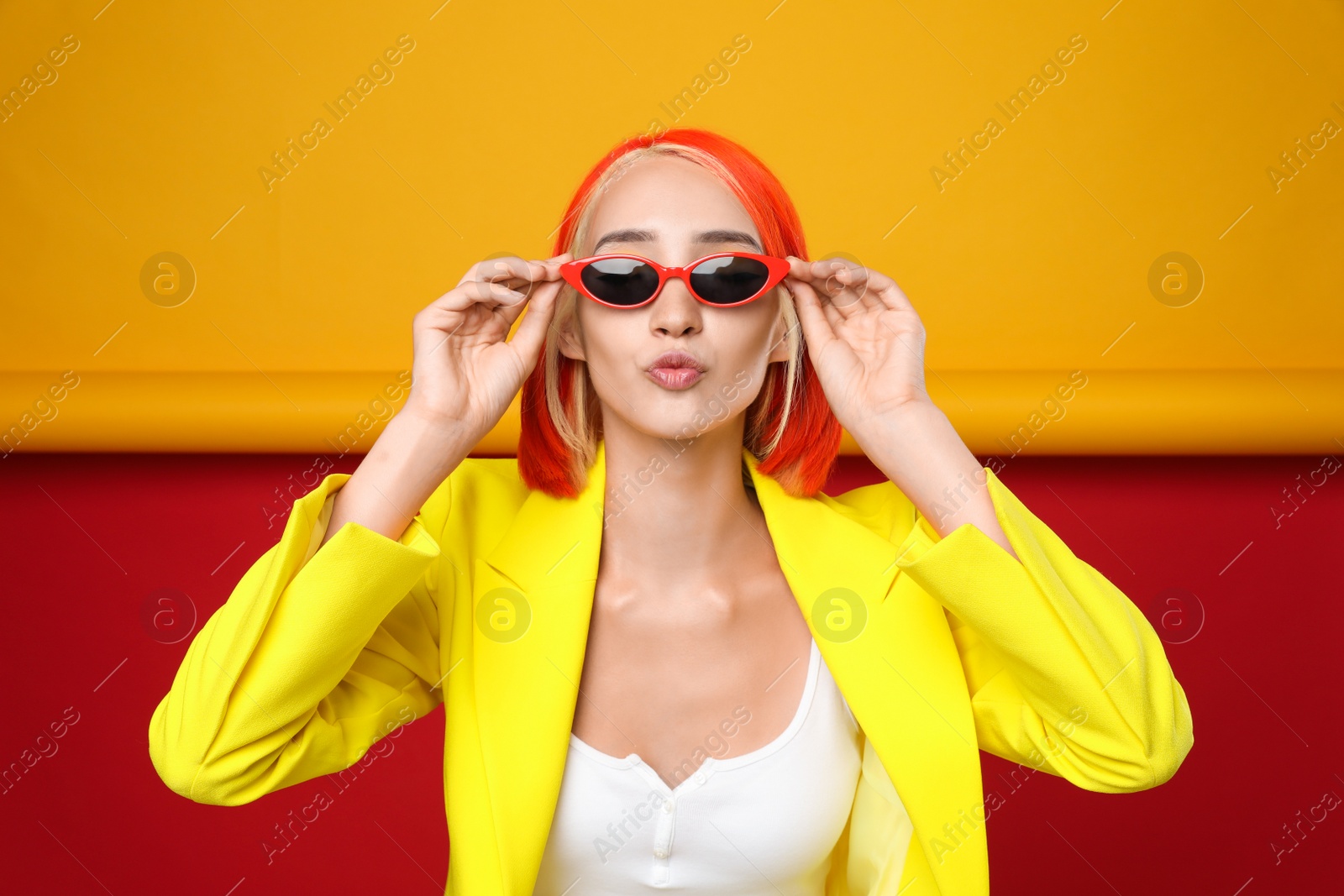 Photo of Beautiful young woman with bright dyed hair on color background