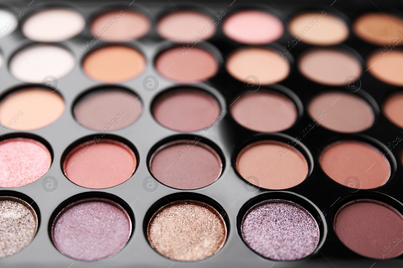 Photo of Beautiful eyeshadow palette as background, closeup. Professional cosmetic product