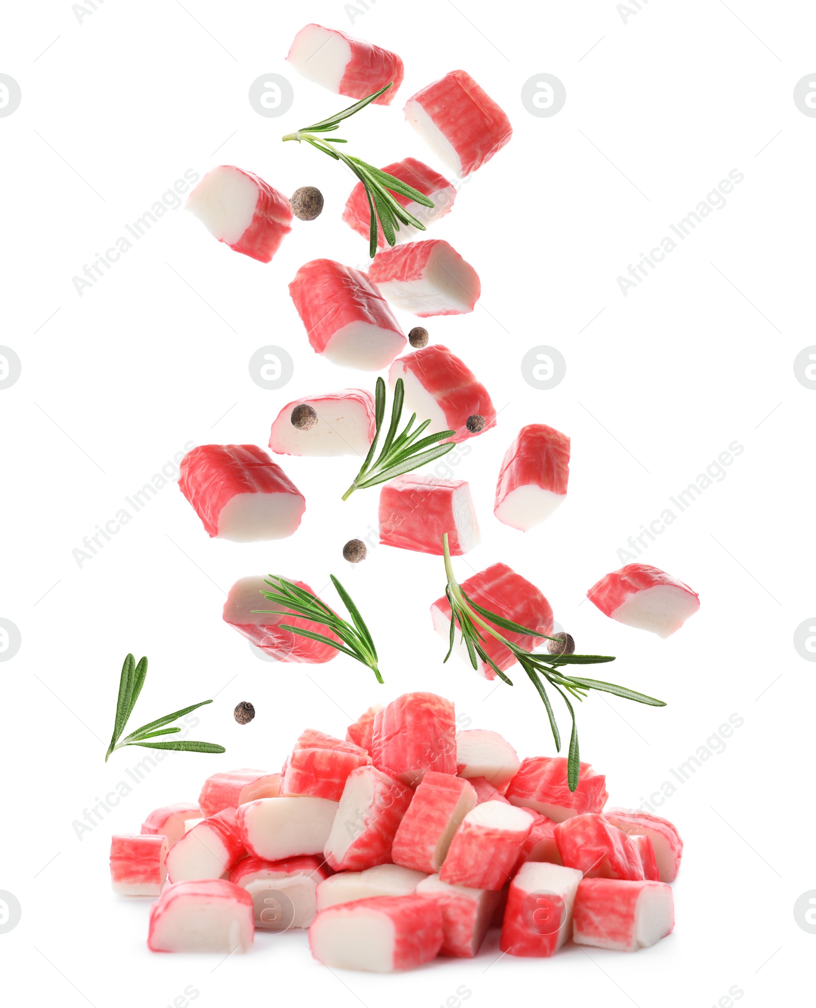 Image of Cut fresh crab sticks, rosemary and allspice falling on white background