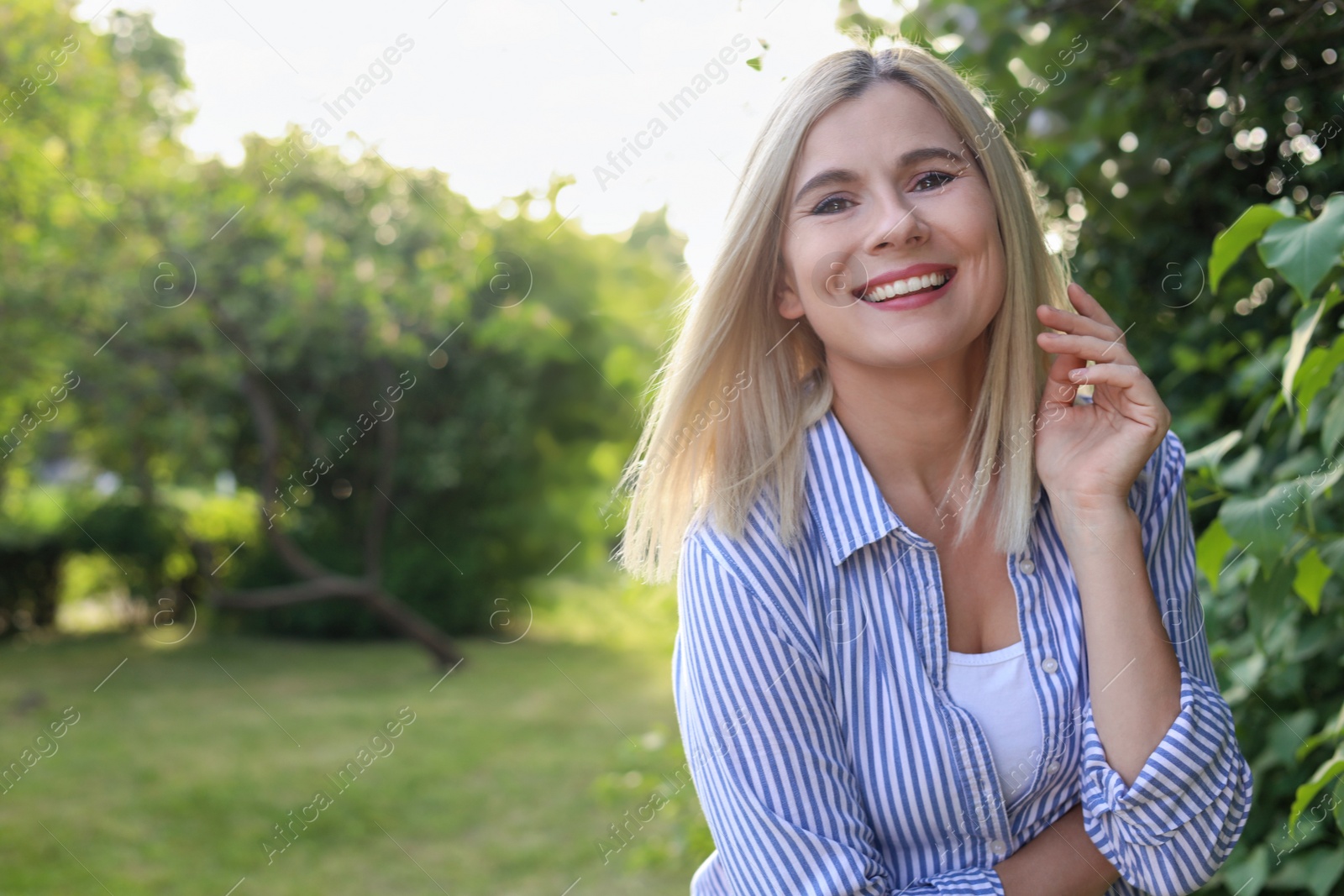 Photo of Portrait of beautiful woman outdoors on sunny day, space for text