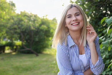 Portrait of beautiful woman outdoors on sunny day, space for text