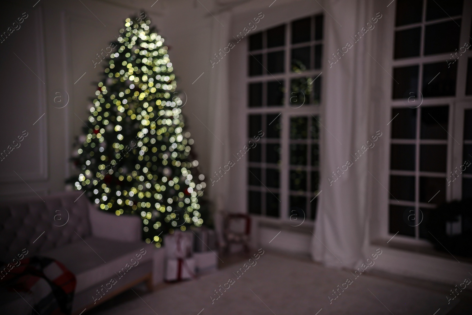 Photo of Blurred view of modern living room with Christmas tree