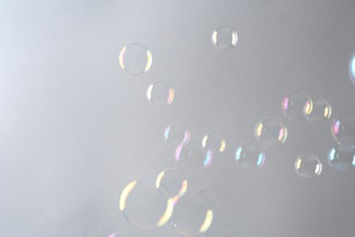 Beautiful transparent soap bubbles on gray background