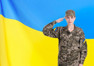 Soldier in military camouflage uniform and Ukrainian flag on background, space for text. Stop war