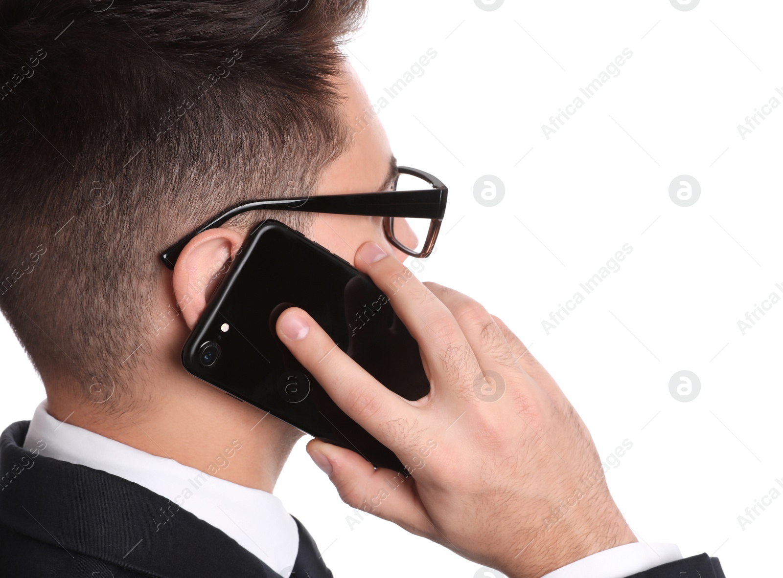 Photo of Young businessman talking on smartphone against white background