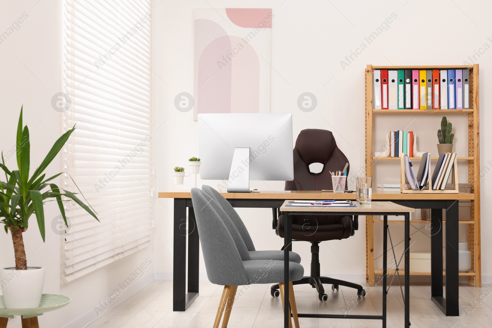 Photo of Director's office with large wooden table and comfortable armchairs. Interior design