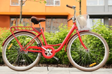 Modern color bicycle with basket in park