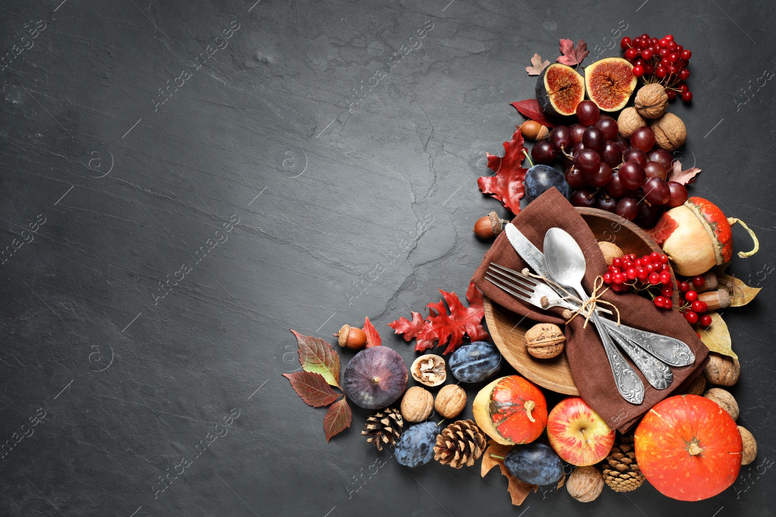 Photo of Flat lay composition with cutlery, autumn vegetables and fruits on grey background, space for text. Happy Thanksgiving day