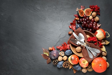 Photo of Flat lay composition with cutlery, autumn vegetables and fruits on grey background, space for text. Happy Thanksgiving day