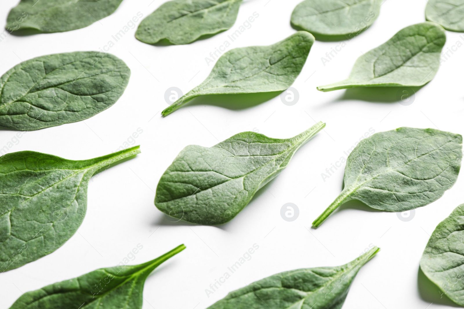 Photo of Fresh green healthy spinach leaves on white background