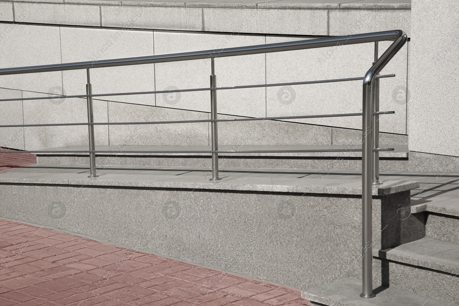 Photo of Ramp with metal handrail near building outdoors