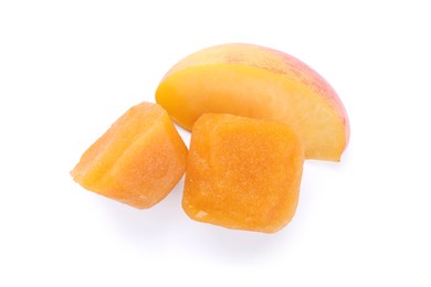 Frozen nectarine puree cubes and fruit on white background, top view