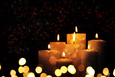 Image of Burning candles on dark background, bokeh effect