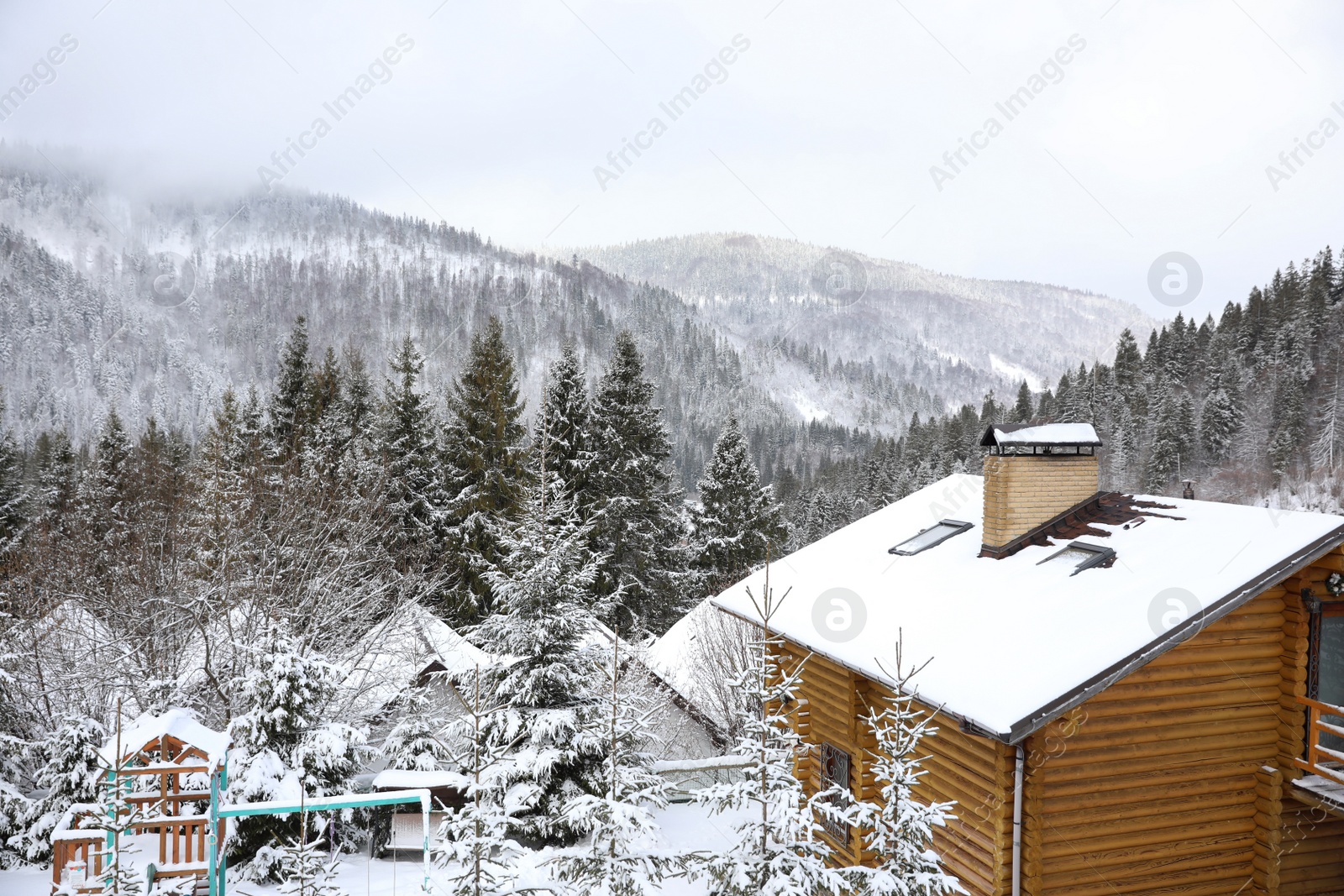 Photo of Beautiful landscape with cottage on snowy winter day