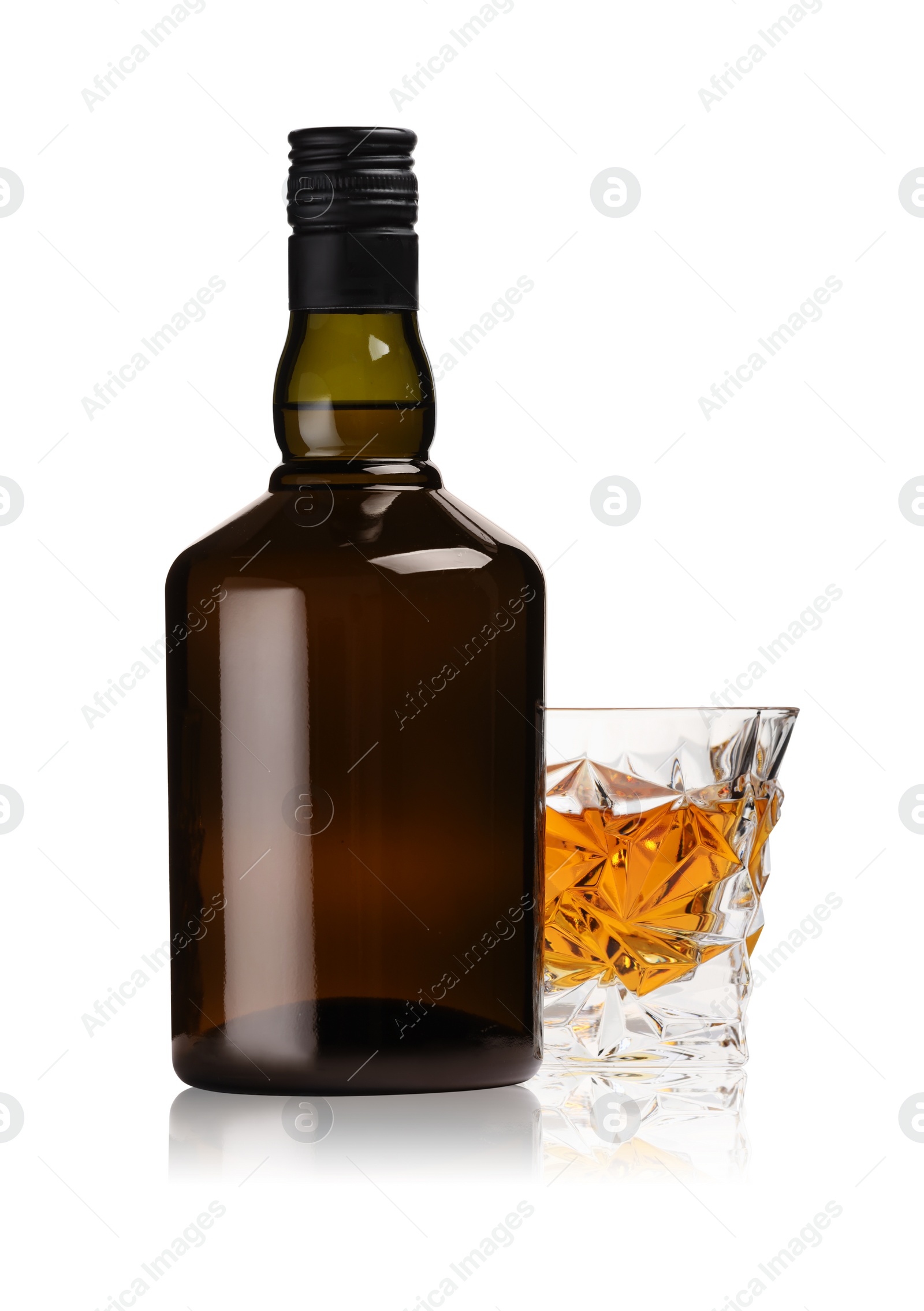 Photo of Glass and bottle of whiskey isolated on white