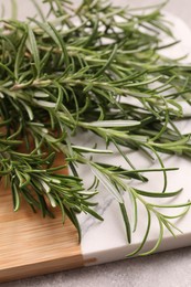 Photo of Sprigs of fresh rosemary on table, closeup