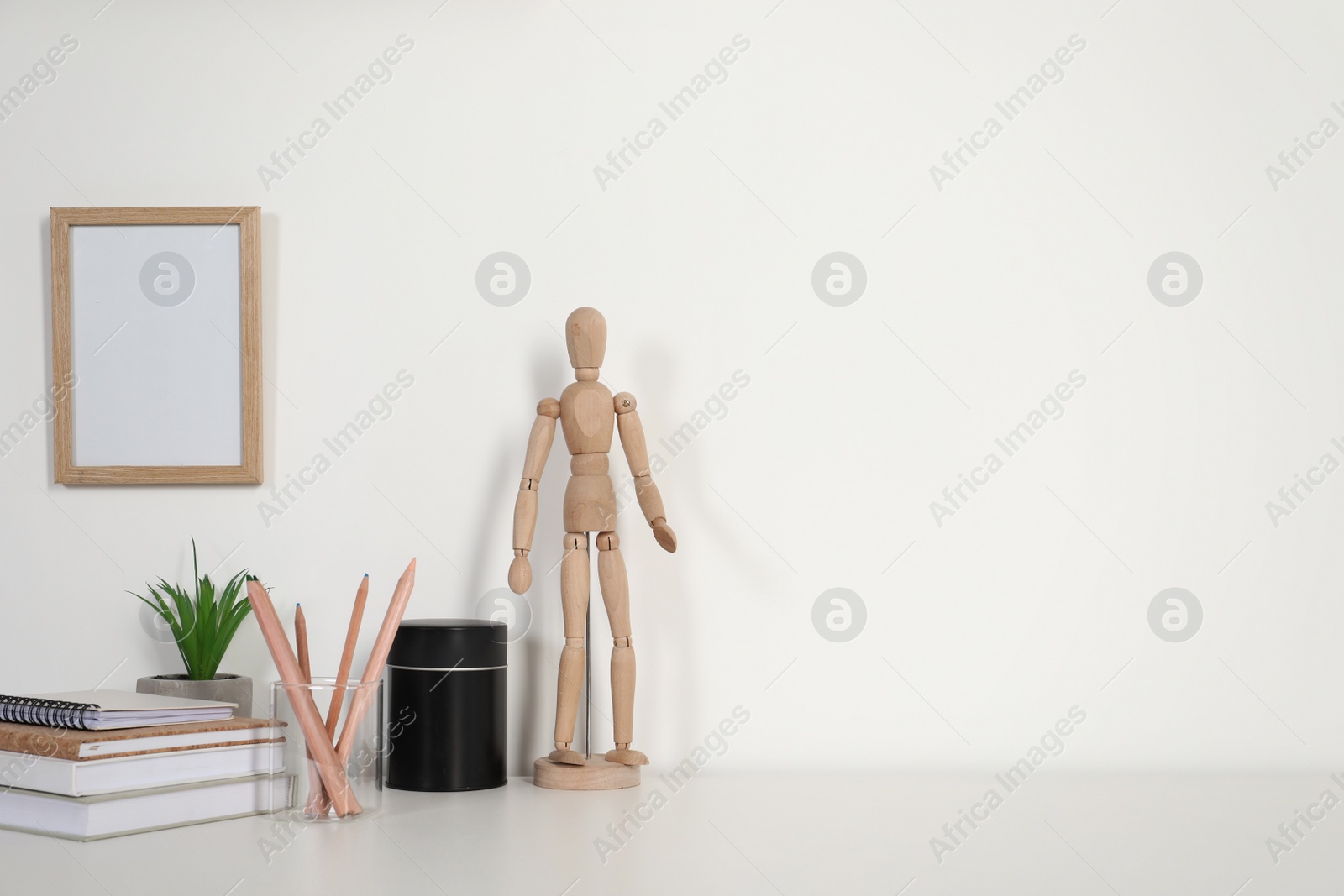 Photo of Comfortable workplace with white desk near wall at home